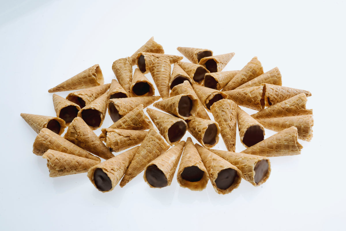 Loose Dark Choc Tippies tipped out of the pouch — waffle cone tips with a dark chocolate flavoured filling